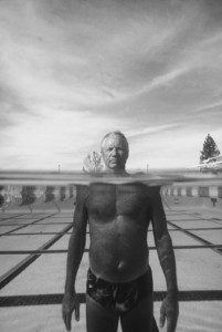 I was in a wetsuit and had a scuba tank in teeth chattering cold water. This stoic guy never shivered once. This split-level photography calls for a complex array of underwater housing and filters. UT, Univ. of Utah. Senior swimmer.